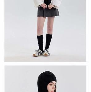 Detail of black knitted balaclava hood showing vertical ribbed texture and snug fit