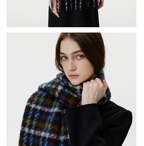 Detailed view of checkered mohair scarf featuring blue and black plaid with soft tassels