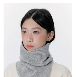 Detailed view of grey ribbed knit neck warmer with soft texture on female model
