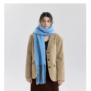 Detail of light blue wool blend scarf with fringe and subtle stripes on khaki blazer