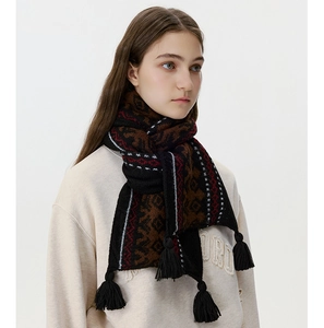 Close-up of Fair Isle knit scarf featuring geometric patterns and thick black tassels