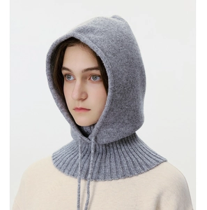 Detail view of light grey knit balaclava showing soft texture and ribbed neck design