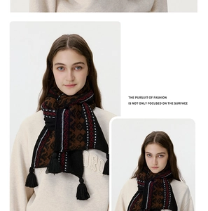 Close-up of geometric jacquard knit scarf with thick black tassel details for winter