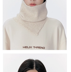Macro detail of beige ribbed knit texture with Helix Thread logo on the high neck warmer