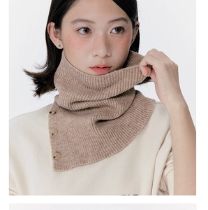 Close-up of brown ribbed knit neck warmer featuring marble-patterned decorative buttons