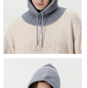 Close-up of gray knit balaclava hood featuring adjustable drawstrings and ribbed textures