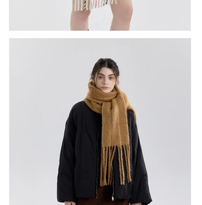 Detailed texture of caramel wool-blend striped scarf with long tassels for winter
