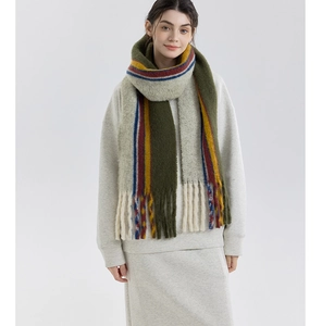 Close-up of thick wool blend knit scarf with colorful stripes and tassel details