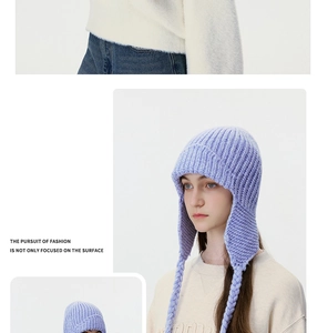 Detail view of lavender cable knit trapper hat with earflaps and braided tassels