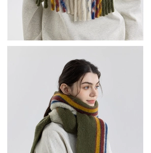 Detail of wool blend scarf featuring colorful stripes and long fringe tassels