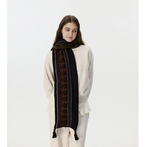 Detail of Fair Isle wool blend scarf showing geometric patterns and fringe textures