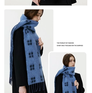 Detail view of the thick plaid wool scarf texture with long fringe tassels