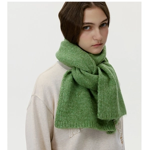 Detailed close-up of grass green wool knit scarf showing thick ribbed texture and fuzzy wool