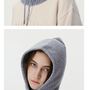 Detail of grey knitted hood and cream fabric texture on a warm balaclava hoodie