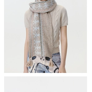 Close-up of Fair Isle knit scarf featuring beige and light blue fringe details