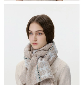 Detailed knit texture of vintage Fair Isle wool scarf with soft camel and blue patterns