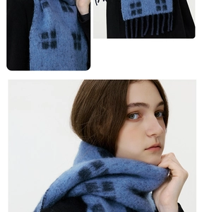 Close-up of blue plaid wool scarf texture and fringe detail for winter warmth