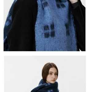 Close-up of soft blue plaid wool tassel scarf showing plush fiber texture and fringe