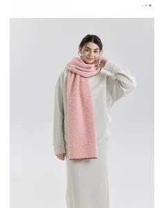 Close-up of thick pink knit scarf with contrasting edge stitching and fleece texture