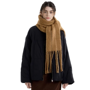 Caramel brown wool blend fringe scarf paired with a black winter puffer jacket