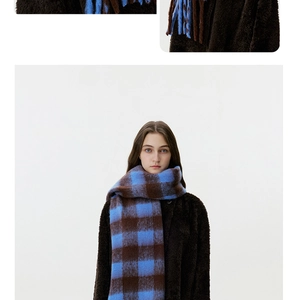 Close-up detail of soft blue and brown checkered cashmere-like winter scarf texture
