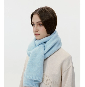 Detailed texture of light blue wool blend knitted scarf with soft fluffy mohair finish