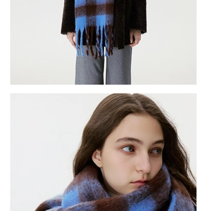 Detail of blue and brown checkered scarf featuring thick mohair texture and long tassels