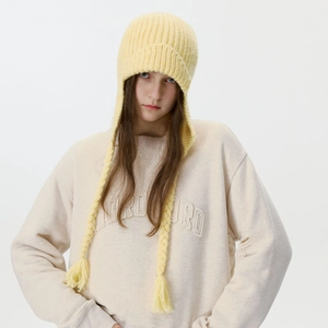 Yellow cable knit earflap hat with long braids and tassels for winter warmth