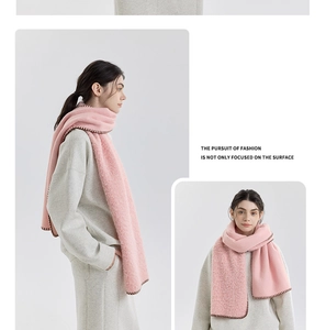 Detail of pink cashmere-like wool scarf with contrast stitching and soft texture