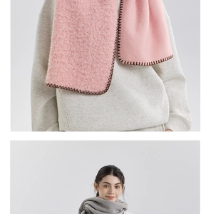 Close-up of thick cashmere-like scarf with hand-stitched blanket edges and soft texture
