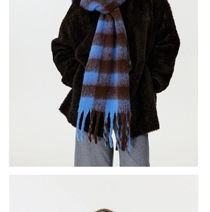 Blue and brown checkered faux cashmere scarf with tassels styled on a model