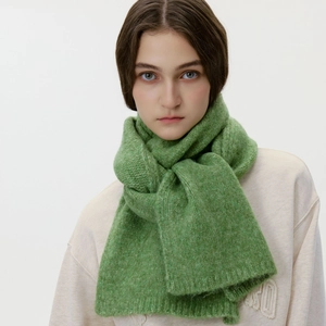 Grass green wool blend knitted scarf for winter shown on a model with a soft plush texture