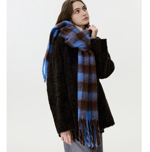 Detail of blue and brown checkered scarf with soft mohair texture and long tassels