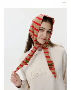 Detail of striped knit balaclava with 3D cherry beads decoration and soft wool texture