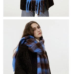 Detail of soft blue and brown checkered scarf with long tassels and plush mohair texture
