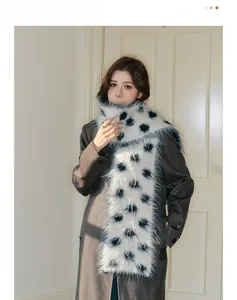 Close-up of soft thick wool scarf featuring navy blue polka dots on white plush fabric