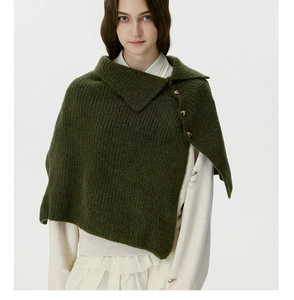 Detail of dark green knit shawl with vintage buttons and chunky textured wool pattern