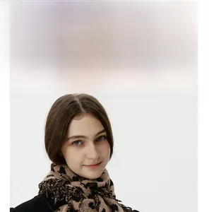 Close-up of leopard print knitted scarf with long fringe details on soft warm fabric