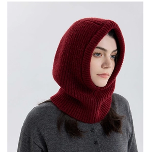 Detail of burgundy wool knit balaclava showing thick ribbed texture on female model