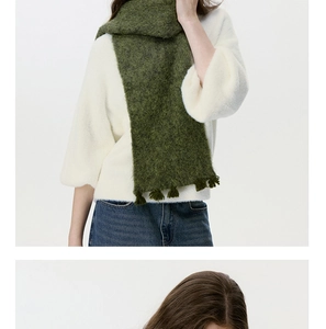 Detail of moss green wool blend scarf showing fuzzy texture and fringe trim for winter