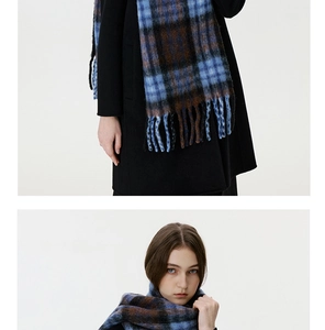 Detail of blue and brown plaid scarf with thick fringe and soft brushed texture