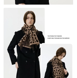 Detailed knit texture and tassel edges of leopard print winter shawl scarf for women