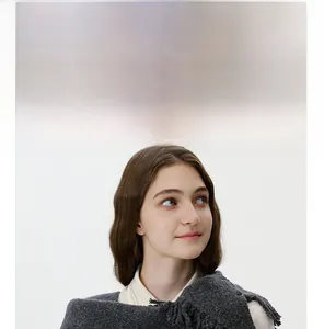 Detailed knit texture and tassel edges of a dark grey wool triangle scarf for women