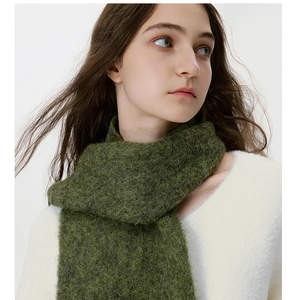 Close-up of soft dark green mohair blend scarf with premium fluffy texture and fringe