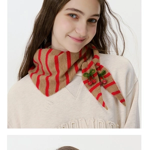Detailed view of striped wool knit scarf with handmade beaded cherry charm and sequins