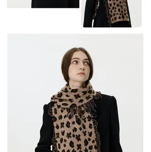 Close-up of leopard print knitted scarf showing detailed fringe edges and soft texture