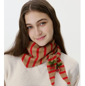 Detail of wool knit striped triangle scarf with sparkling cherry accent for women