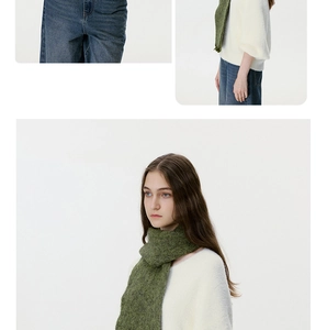 Detailed texture of moss green wool blend knit scarf with fringes on a female model
