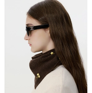 Detail of wool knit headscarf with yellow floral embroidery and soft brown texture