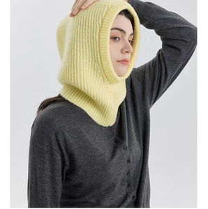 Detailed texture of bright yellow ribbed knit wool blend balaclava hat for winter warmth